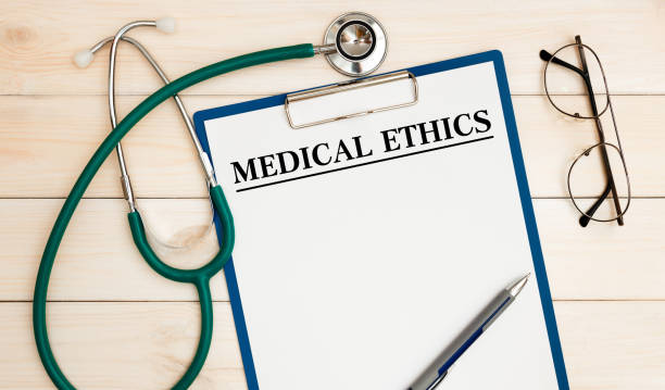 Worksheet with the inscription Medical Ethics, stethoscope, glasses, pen stock photo