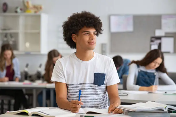 Photo of African guy thinking in class