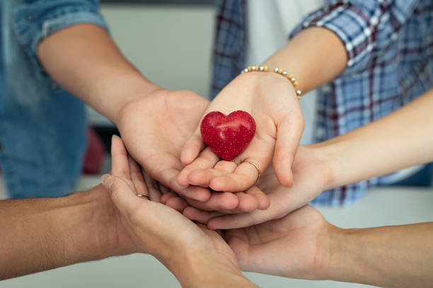 Young friends holding heart stone