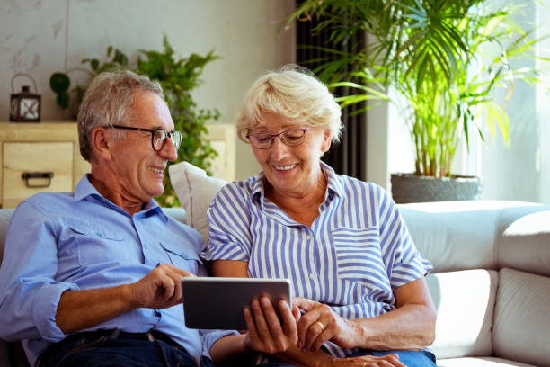 istock Senior couple using digita tablet at home 1278976493