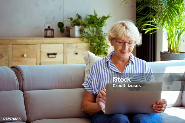 Senior Woman Using Laptop At Home Stock Photo - Download Image Now - Domestic Life, Laptop, Senior Adult