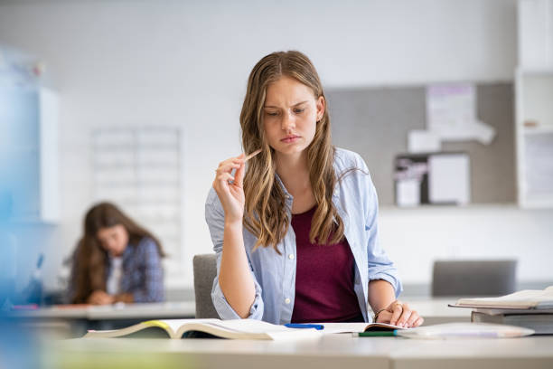 nachdenkliche mädchen in der high school studieren - schoolgirl teenager teenage girls teenagers only stock-fotos und bilder