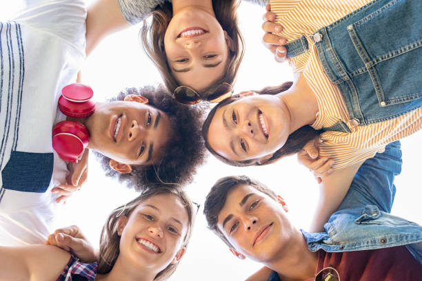 group of friends hugging and having fun together - high school student imagens e fotografias de stock