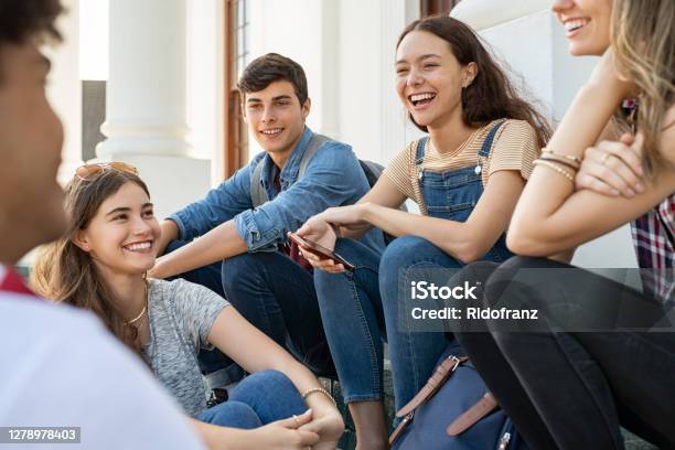 Teenager Friends Sitting Together And Laughing Stock Photo - Download Image Now - Teenager, Adolescence, Young Adult