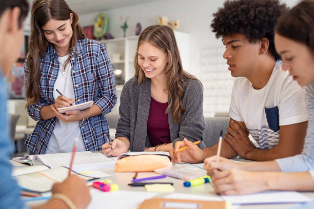 group of college students studying together - highschool student imagens e fotografias de stock