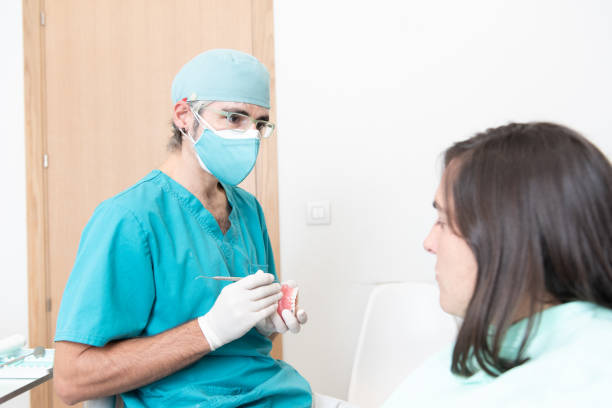 istock Dentist talking to a patient 1278979578
