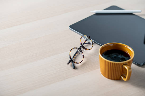 istock Digital tablet on table with stylus pen,cup of coffee,eyeglasses. Technology lifestyle image. 1278980129