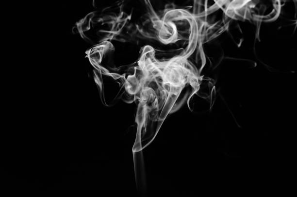 istock abstract fragment movement of white smoke on black background. 1278980916