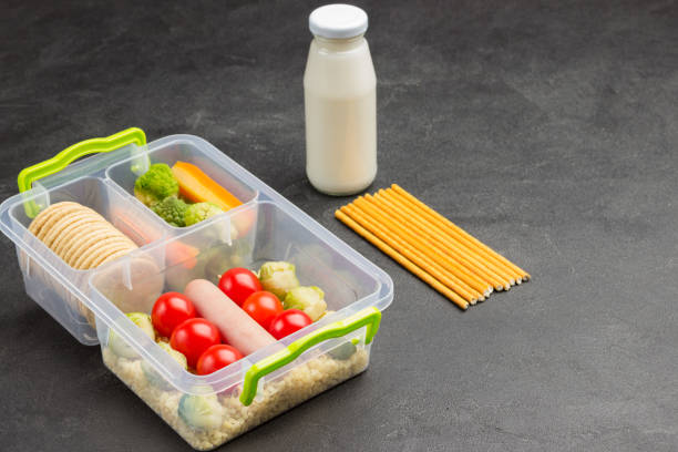 istock Lunch box with sausage and vegetables, round biscuits. 1278982640