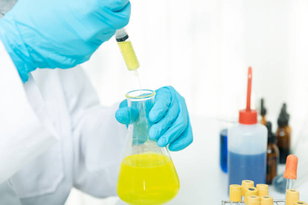 istock Researcher or scientists loads liquid sample into beaker in laboratory. Researchers are developing vaccines and medicine to treat the COVID-19 virus. 1278987739