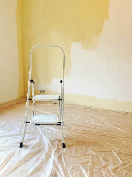 istock House beige wall with ladder during renovation. Floor covered with plastic 1278990706