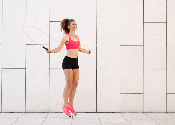 istock Athletic woman with jumping rope training near wall 1278990926