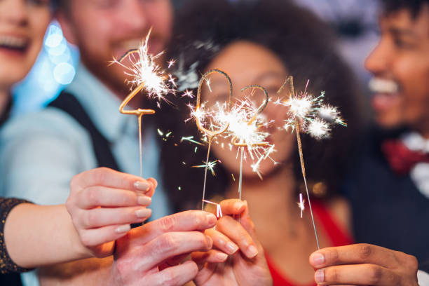 istock Smiling people holding sparklers 1278990953