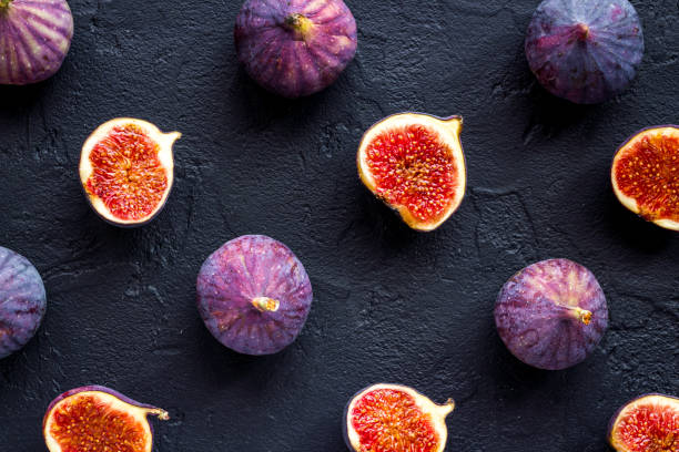 istock Pattern of whole and sliced figs. Overhead view 1278993373