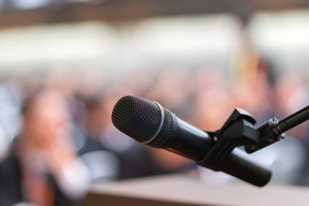 istock hand hold Microphone in meeting room for a conference 1278993598