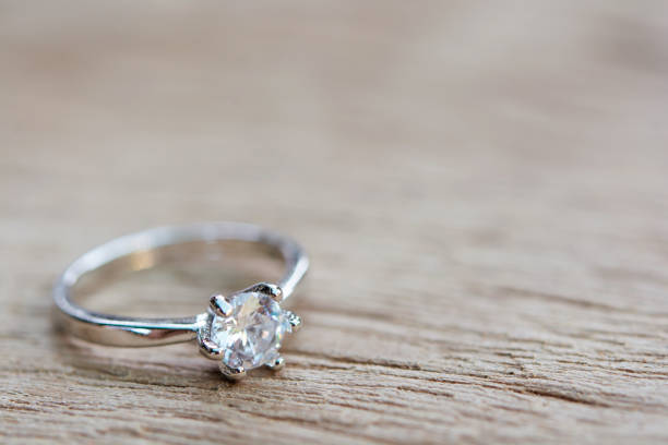 Diamond ring, wedding ring on plank wooden