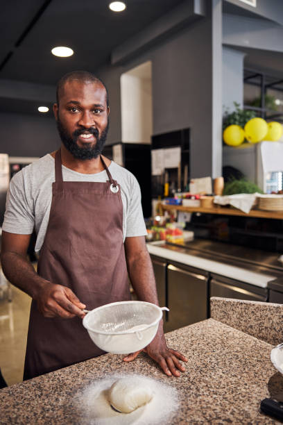 istock Happy young chef preparing dough in restaurant 1278994641