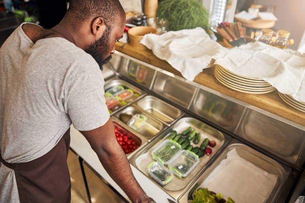 istock Young man cooking in professional restaurant kitchen 1278994700