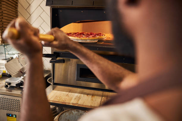istock Bearded man baking tasty dishes in oven 1278994704