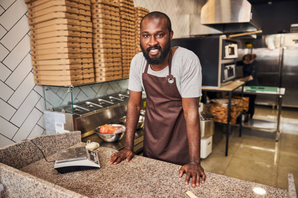 istock Cheerful young bearded chef working in pizzeria 1278994737