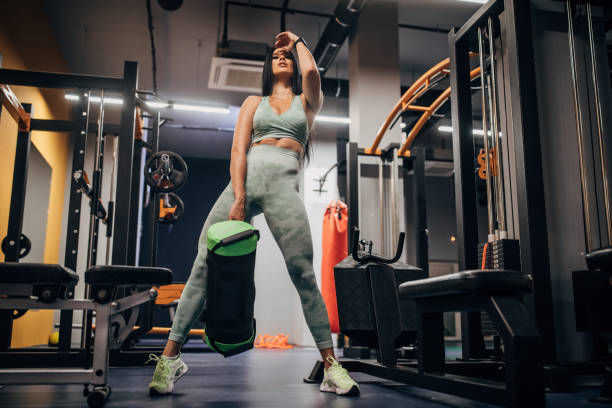 istock Beautiful fit woman exercising alone in gym 1278997321