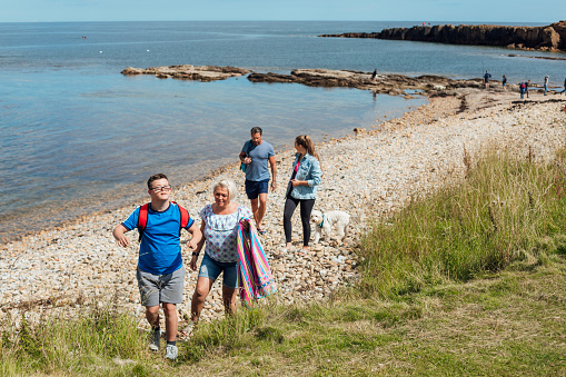 A family with two teenage children enjoying a day out along the coastal region of Northumberland.
