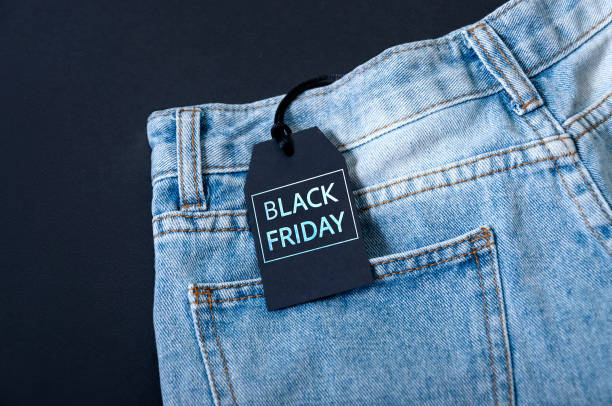 istock Black Friday Concept. Mock-up Tag Jeans on Dark Background 1279001818