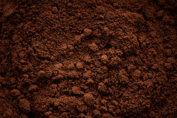 Top view close-up of grinded coffee beans Top view close-up of grinded coffee beans grinding stock pictures, royalty-free photos & images