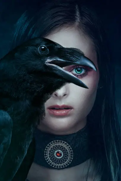 Portrait of beautiful woman with crow