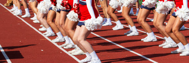 gambe di cheerleader che tifano durante una partita a bordo campo - homecoming foto e immagini stock