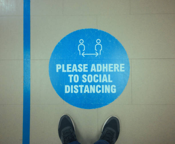 istock Blue warning sign to maintain keep social distance 1279004130