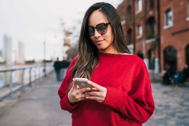 istock Young woman using her mobile phone. 1279004196