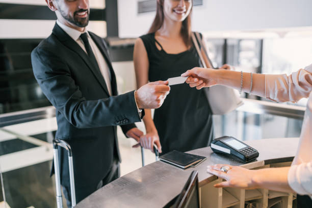istock Business people makes card payment at check-in at reception. 1279004295