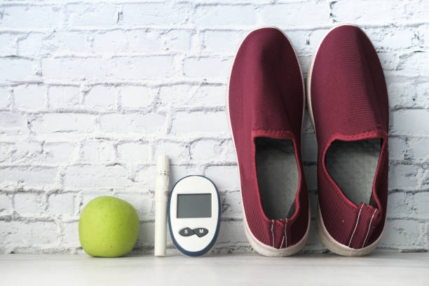istock diabetic measurement tools, shoe and apple on table 1279005448