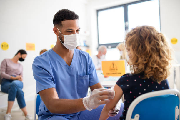 istock Child with face mask getting vaccinated, coronavirus, covid-19 and vaccination concept. 1279005617