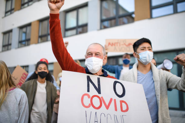 istock People with placards and posters on public demonstration, no covid vaccine concept. 1279005679