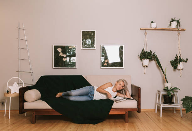 istock Two girlfriends on a sofa read the magazine 1279006883