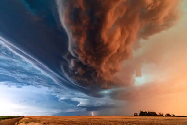 Supercell thunderstorm with dramatic storm clouds at sunset during a severe weather outbreak in Kansas.