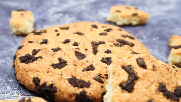 istock One soft, freshly baked chocolate chip cookie on a gray marble kitchen countertop. American traditional dessert. Delicious sweet food. Homemade baking concept for the holiday. Culinary background 1279011393
