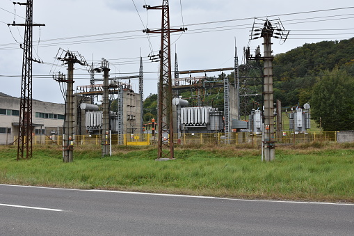 Electrical station. High voltage equipments on power station. Industrial distribution of electricity. High voltage lines on electric substation.