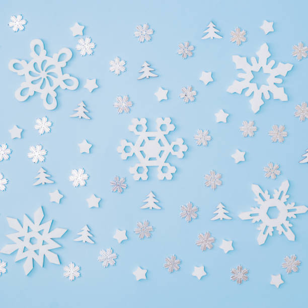 istock Flat lay pattern with snowflakes and christmas decorationon a blue background 1279012782