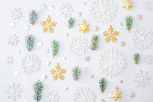 istock Flat lay pattern with fir branches, christmas baubles decoration and snowflakes on a white background 1279012792