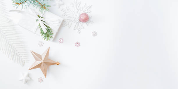 istock Flat lay frame with fir branches, christmas baubles decoration and gift box on a white background 1279012821