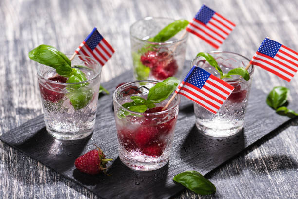 Alcohol shots of berries cocktail with a raspberry