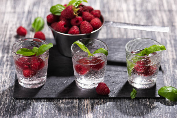istock Alcohol shots of berries cocktail with a raspberry 1279012859