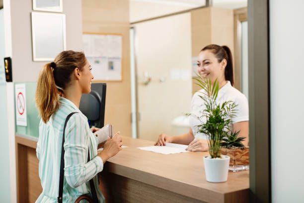istock Happy woman talking to a receptionist while arriving at the spa. 1279015246