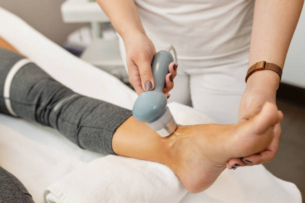 istock Close-up of physical therapist treating client's joint with electrotherapy. 1279016415