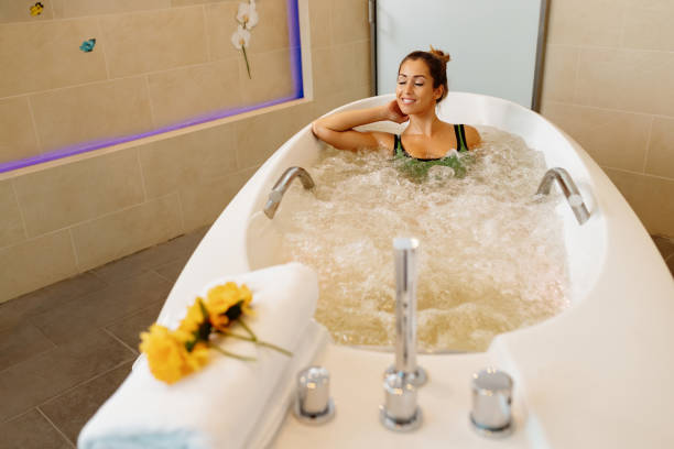 istock Young beautiful woman enjoying in hydromassage during spa treatment. 1279017720