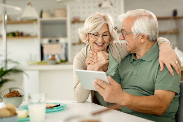istock Happy senior couple using digital tablet at home. 1279017738