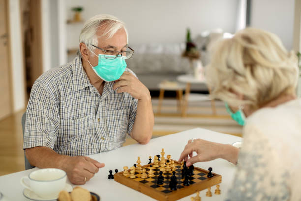 istock Senior couple playing chees at home during COVID-19 lockdown. 1279020008